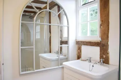 a bathroom with two sinks and a mirror at Church Farmhouse, Cookley in Halesworth