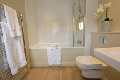 a bathroom with a tub and a toilet and a sink at Tamarisk, Aldeburgh in Aldeburgh