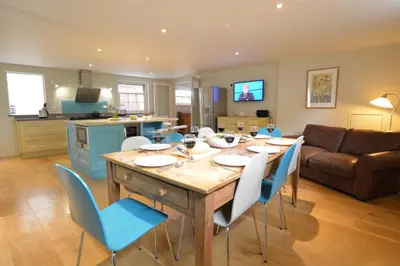 a kitchen and living room with a table and chairs at Tamarisk, Aldeburgh in Aldeburgh