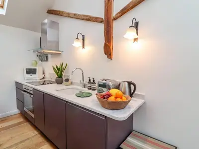 a kitchen with a bowl of fruit on a counter at The Bothy at Snape Hall in Snape
