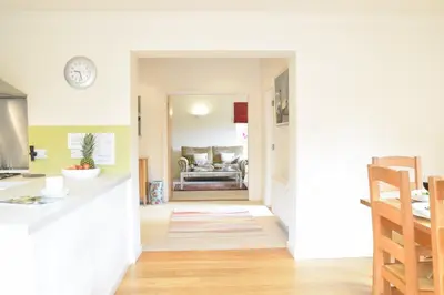 a kitchen and a living room with a table at Peach House, Aldeburgh in Aldeburgh