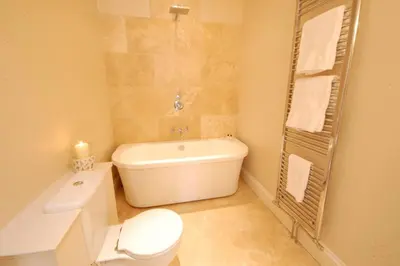 a bathroom with a tub and a toilet and a sink at High Tide, Crabbe Street, Aldeburgh in Aldeburgh
