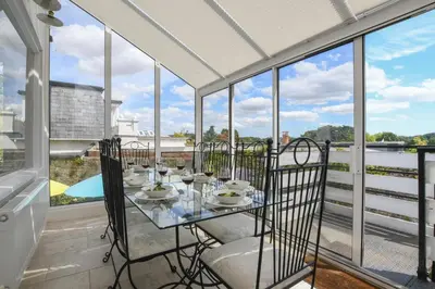 a balcony with a table and chairs and windows at Beresford House in Woodbridge