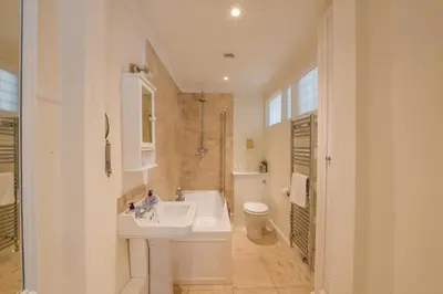 a white bathroom with a sink and a toilet at Beresford House in Woodbridge