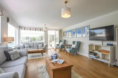 a living room with a couch and a tv at Beresford House in Woodbridge