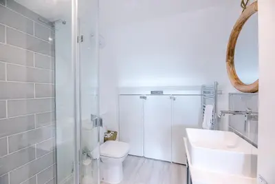 a white bathroom with a toilet and a sink at Coasters, Aldeburgh in Aldeburgh