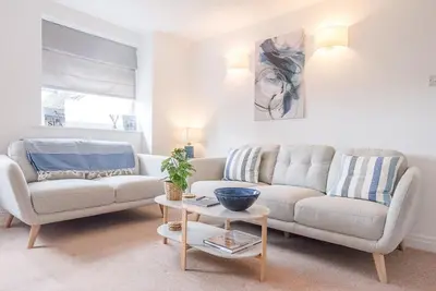 a living room with a couch and a table at Coasters, Aldeburgh in Aldeburgh