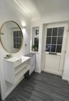 a white bathroom with a mirror and a sink at Newly refurbished modern 2 bedroom flat in Trimley Heath