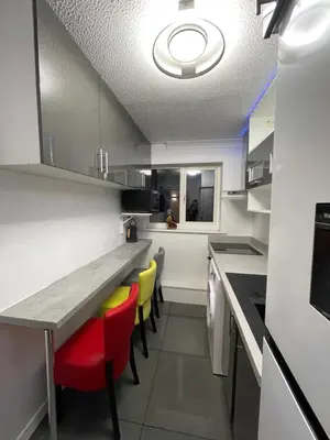 a kitchen with a table and some yellow chairs at Newly refurbished modern 2 bedroom flat in Trimley Heath