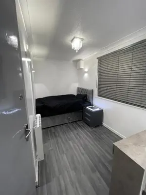 a small room with a bed and a window at Newly refurbished modern 2 bedroom flat in Trimley Heath