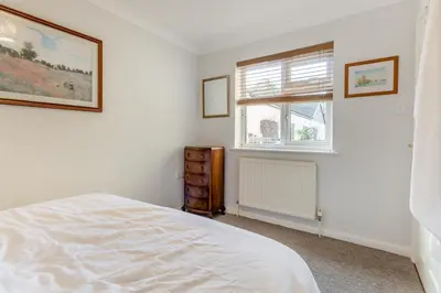 a white bedroom with a bed and a window at 3 Bed in Theberton oc-1pcs in Theberton