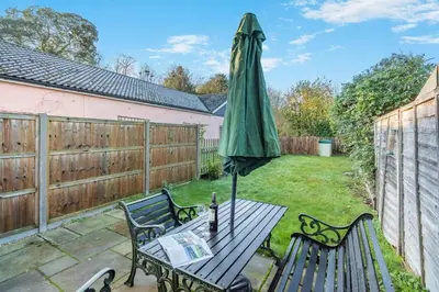 a patio with a table with an umbrella at 3 Bed in Theberton oc-1pcs in Theberton