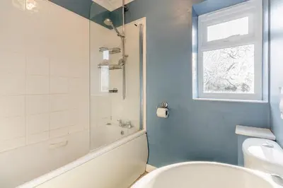 a bathroom with a tub and a toilet and a window at 3 Bed in Theberton oc-1pcs in Theberton