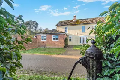 a black fire hydrant in front of a house at 3 Bed in Theberton oc-1pcs in Theberton