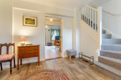 a living room with a staircase and a dresser and a desk at 3 Bed in Theberton oc-1pcs in Theberton