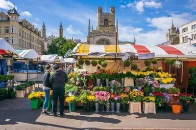 a group of people standing in front of a flower market at Quaint 2 bed Cottage in the Heart of Cambridge in Cambridge