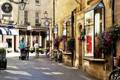 a city street with people walking down a street at Quaint 2 bed Cottage in the Heart of Cambridge in Cambridge