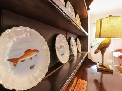 a display of plates on a wall with birds on them at Warren Cottage in Leavenheath