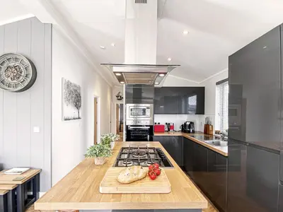 a kitchen with a counter top and a stove top oven at Alde Lodge by The Suffolk Cottage Collection in Aldeburgh