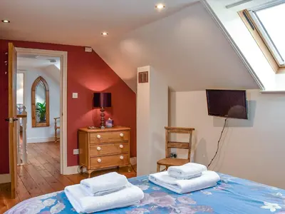 a bedroom with a bed with two towels on it at The Old Butcher's Shop in Wereham