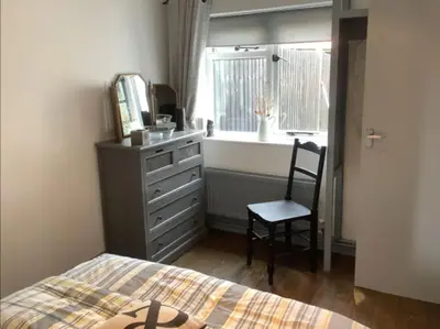 a bedroom with a bed and a dresser and a mirror at Middle Tree, ideal modern cottage in Alburgh