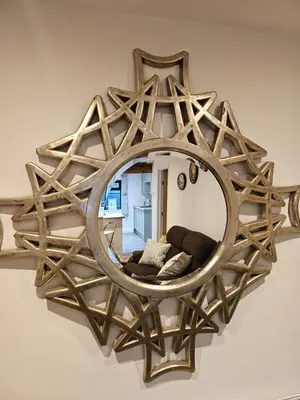 a large wooden mirror hanging on a wall at Middle Tree, ideal modern cottage in Alburgh