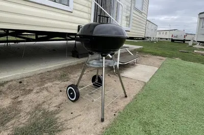 a grill sitting in front of a house at Caravan - Sleeps 10 - Pet friendly - Parking in Clacton-on-Sea