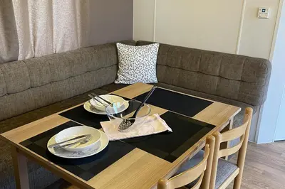 a table with plates and silverware on top of a couch at Caravan - Sleeps 10 - Pet friendly - Parking in Clacton-on-Sea