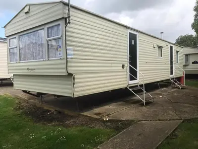 a mobile home is parked in a parking lot at Summer plot 8 in Jaywick Sands