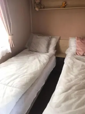 two beds sitting next to each other in a room at Summer plot 8 in Jaywick Sands