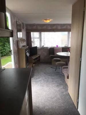 a living room with a couch and a table at Summer plot 8 in Jaywick Sands