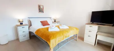 a bedroom with a bed with two towels on it at Modern, well located en-suite rooms with parking - Orbitat Accommodations in Cambridge