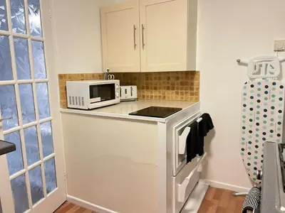 a kitchen with a microwave and a stove at Cambridge Stay Cozy home with Wi-Fi, Parking Perfect for 2 in Cherry Hinton