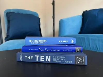 a pile of books sitting on top of a table at Cambridge Stay Cozy home with Wi-Fi, Parking Perfect for 2 in Cherry Hinton