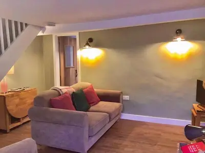 a living room with a couch with pillows on it at Almond Cottage Clare - 2 bedroom English Cottage in Clare