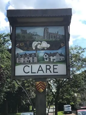 a sign on a pole with a sign for a clinic at Almond Cottage Clare - 2 bedroom English Cottage in Clare
