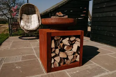 a pile of fire wood in a wooden box at Beautiful Cottage in Bredfield near to Woodbridge on the Suffolk Coast in Bredfield