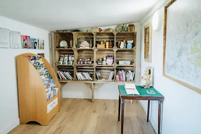 a room with a book shelf and a table at Beautiful Cottage in Bredfield near to Woodbridge on the Suffolk Coast in Bredfield