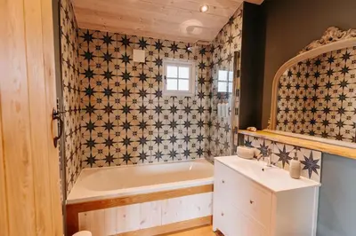 a bathroom with a tub and a sink at Beautiful Cottage in Bredfield near to Woodbridge on the Suffolk Coast in Bredfield