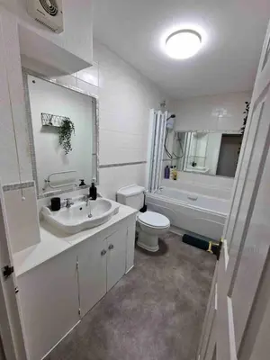 a bathroom with a sink and a toilet and a tub at Two Bedroom Mansion House Apartment By AZ Luxury Stays Newmarket With Parking And WiFi in Newmarket