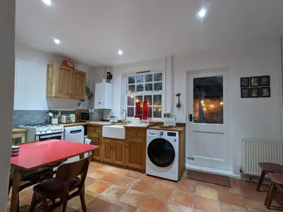 a kitchen with a washer and dryer in it at Arts House in Harwich