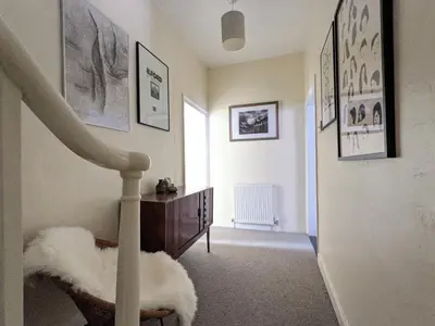 a hallway with a staircase with a stair case and a stair case at Arts House in Harwich