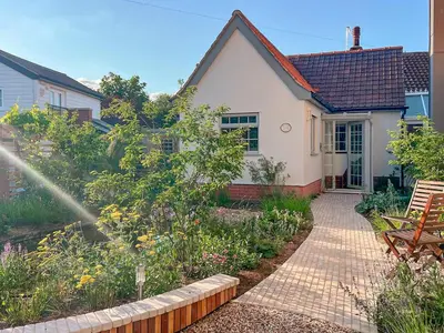 a garden in front of a white house at Quayside Cottage Uk33899 in Waldringfield