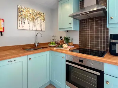 a kitchen with blue cabinets and a sink at The Boathouse Uk33900 in Waldringfield