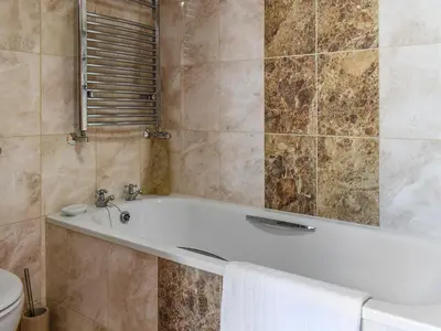 a bathroom with a bath tub and a toilet at The Boathouse Uk33900 in Waldringfield
