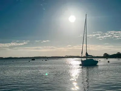 a sailboat sitting in the water on a lake at The Boathouse Uk33900 in Waldringfield