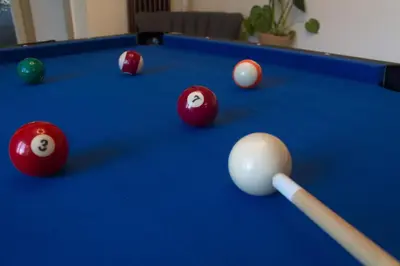 a pool table with a cue and balls on it at Deluxe 4 or 5 Bed House with Hot Tub, Cinema Room Sleeps 15 in Saffron Walden