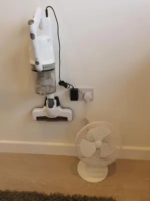a fan sitting on the floor next to a machine at The Tiny Sea Gem in Jaywick Sands