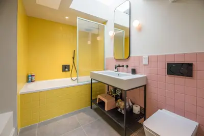 a bathroom with a sink and a tub and a toilet at The Limes, Benhall in Saxmundham