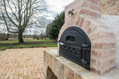 an outdoor brick oven on a brick wall at The Limes, Benhall in Saxmundham